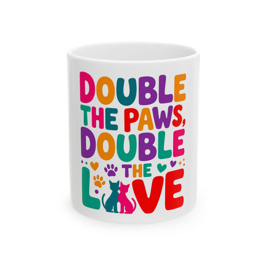 Mug with colorful text "Double the Paws, Double the Love" and cat silhouettes.
