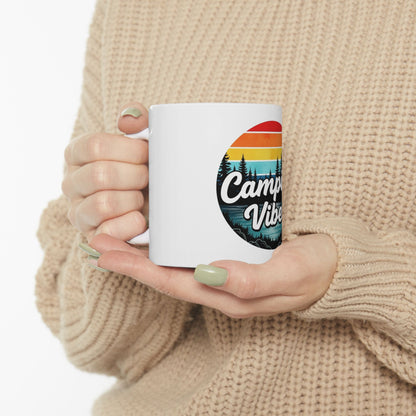 White mug with "Camp Vibes" text and a sunset landscape design.