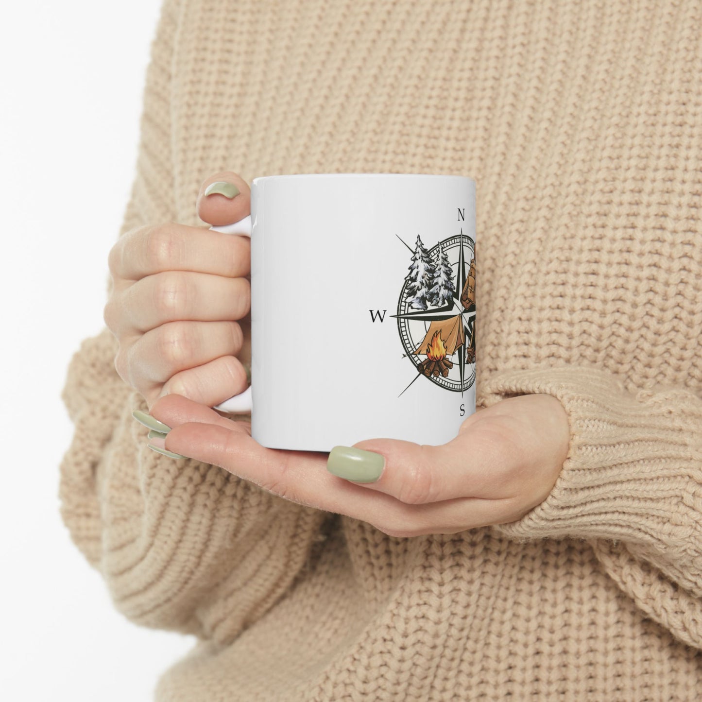 White mug with compass and bear camping graphic.