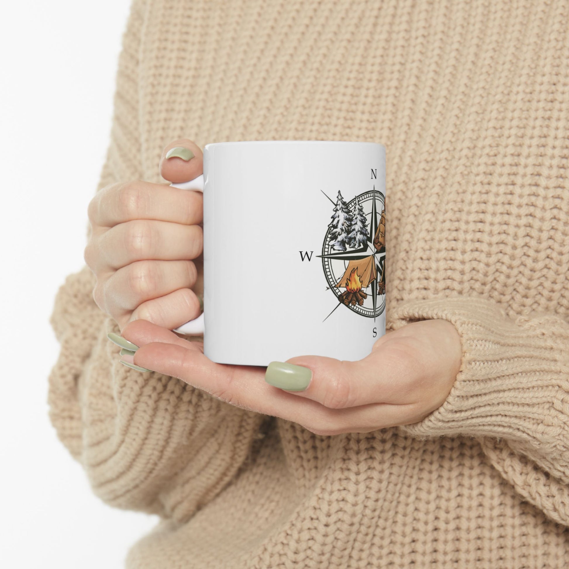 White mug with compass and bear camping graphic.