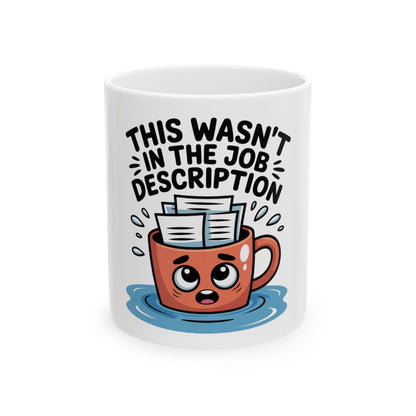 Mug with text "This wasn't in the job description" and a stressed cartoon face.