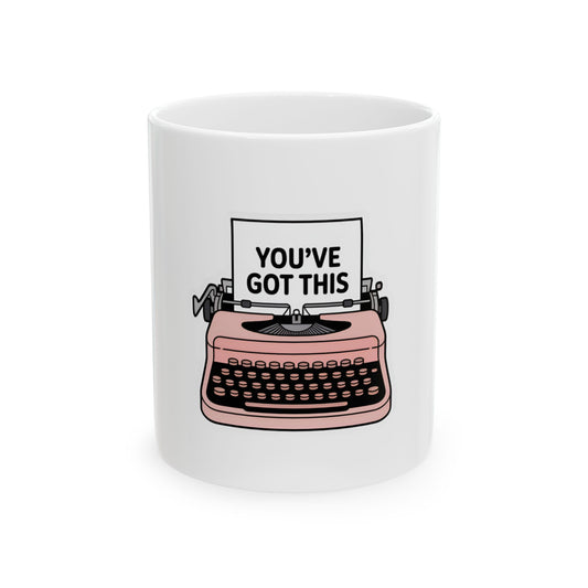 Pink typewriter graphic with "YOU'VE GOT THIS" text on white mug.