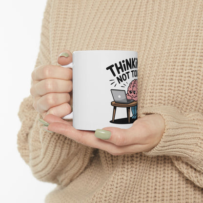 White mug with cartoon brain at laptop, text "Think! Not Too".
