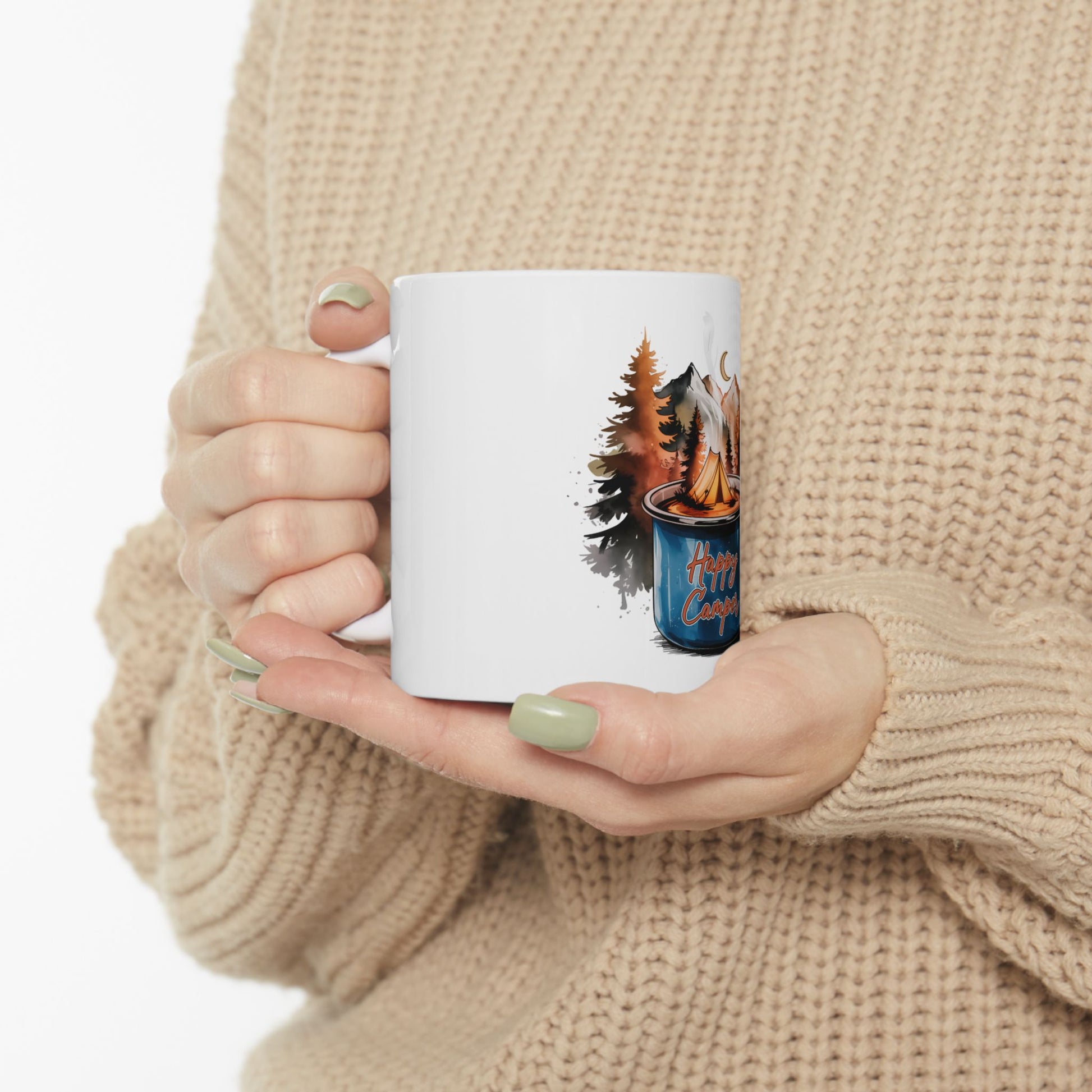 White mug with "Happy Camper" text and forest campfire scene.