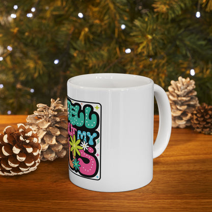 White mug with colorful "Merry & Bright" text and floral designs.