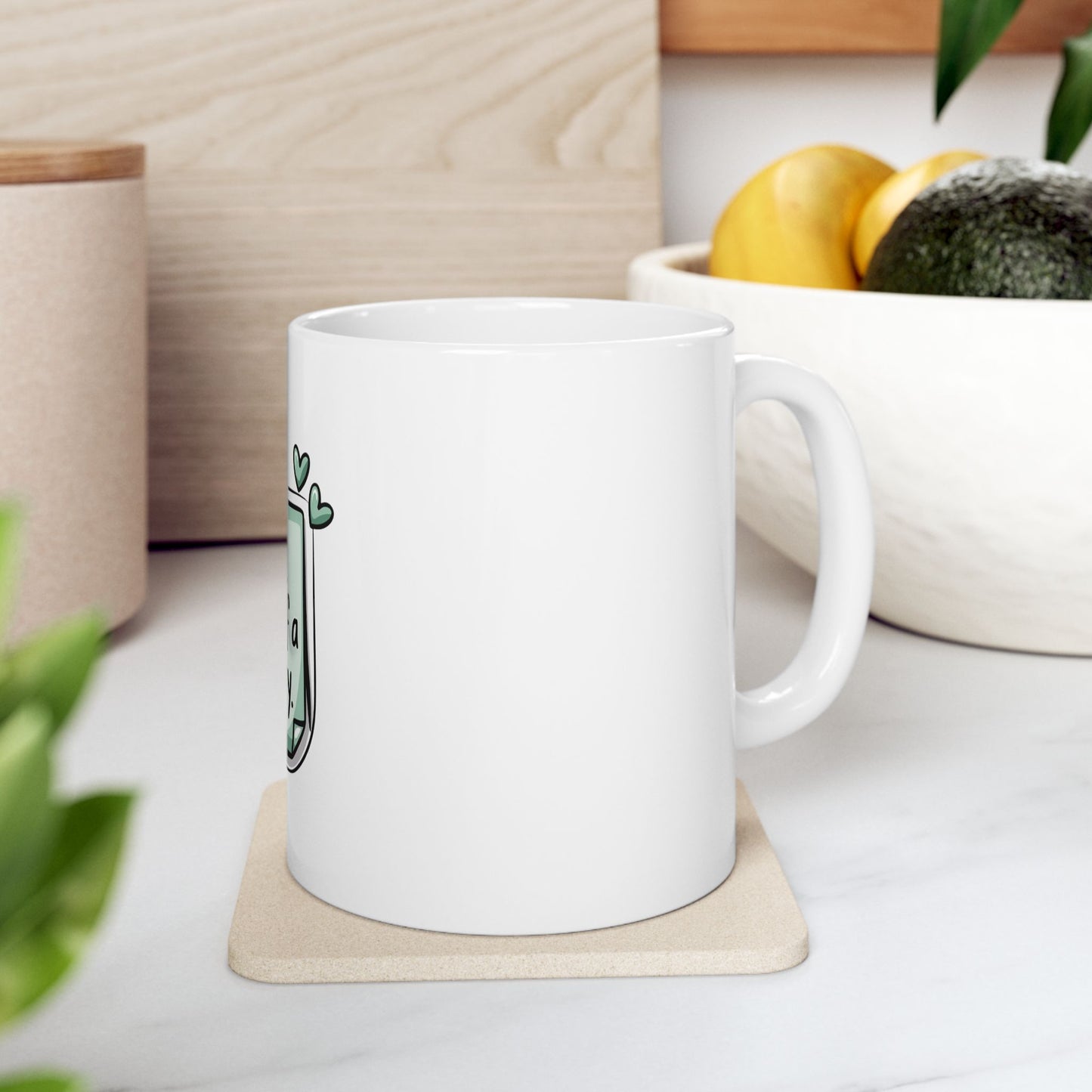 White mug with green heart design and "Let's plant a garden" text.