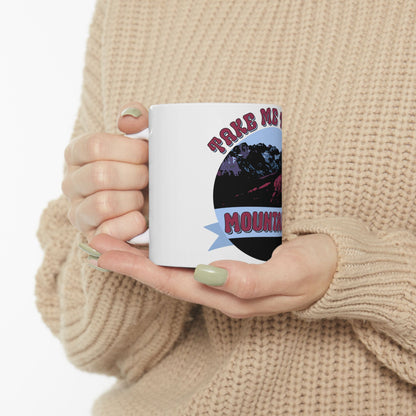 White mug with "Take Me To The Mountains" text and mountain graphic.