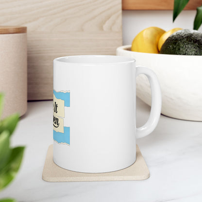 White mug with torn paper graphic saying "Make it happen".