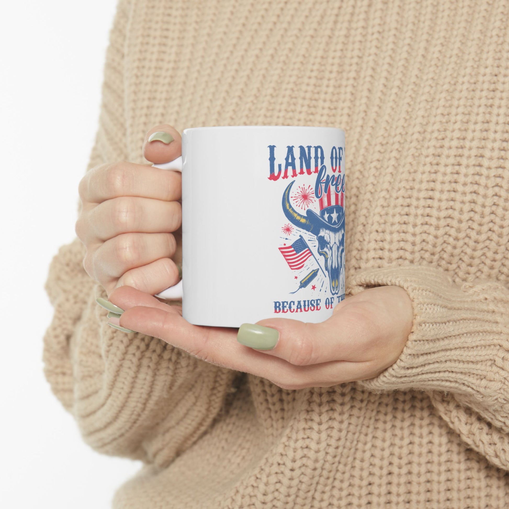 White mug with patriotic bull skull design and "Land of the Free" text.