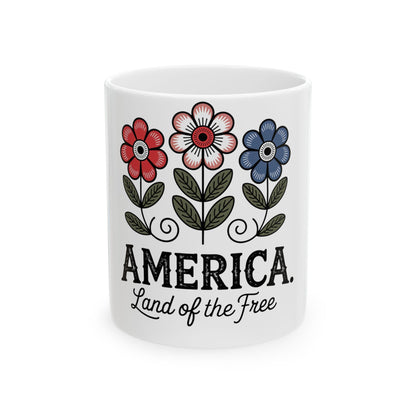 White mug with flowers and text "AMERICA, Land of the Free".