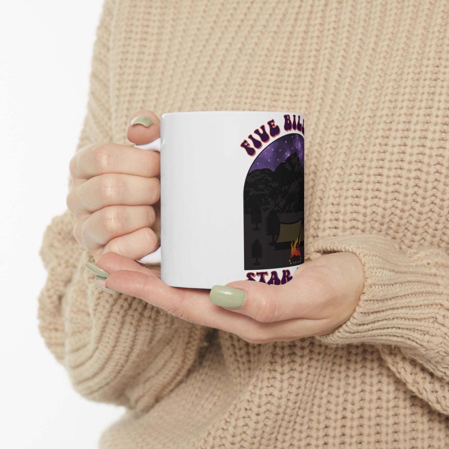 White mug with "Five Billion Star" campsite graphic held by two hands.