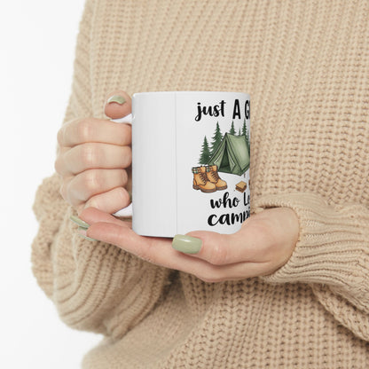 White mug with "just a girl who loves camping" and camping graphics.