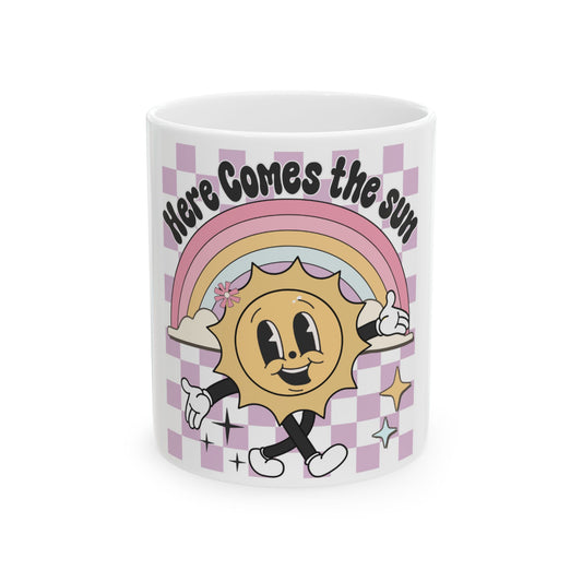 Mug with checkered pattern, smiling sun, and rainbow with text "Here Comes the Sun".