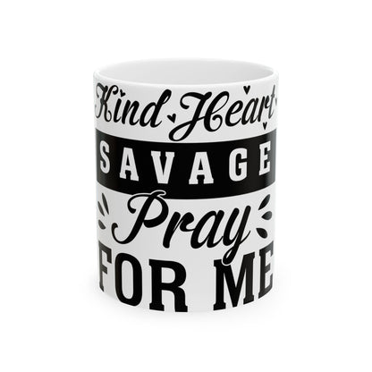 White mug with black text "Kind Heart Savage Pray For Me".