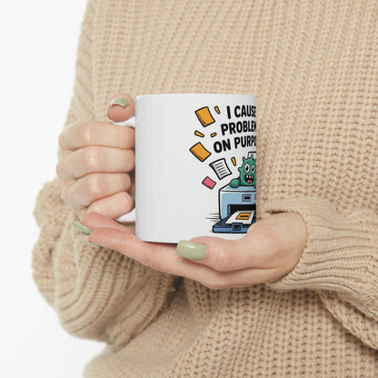 White mug with cartoon monster and text "I cause problems on purpose".