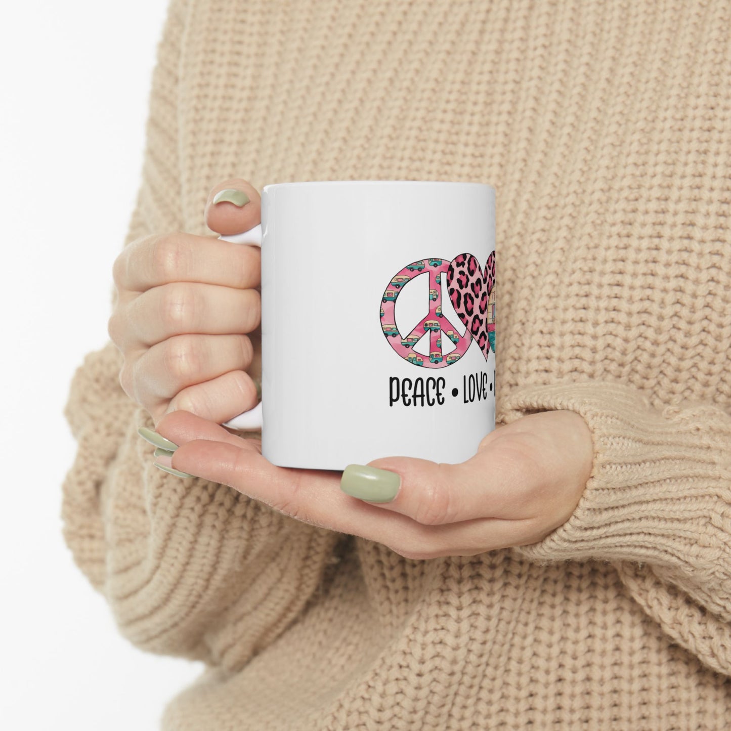 White mug with "PEACE LOVE" text and pink leopard print heart graphic.