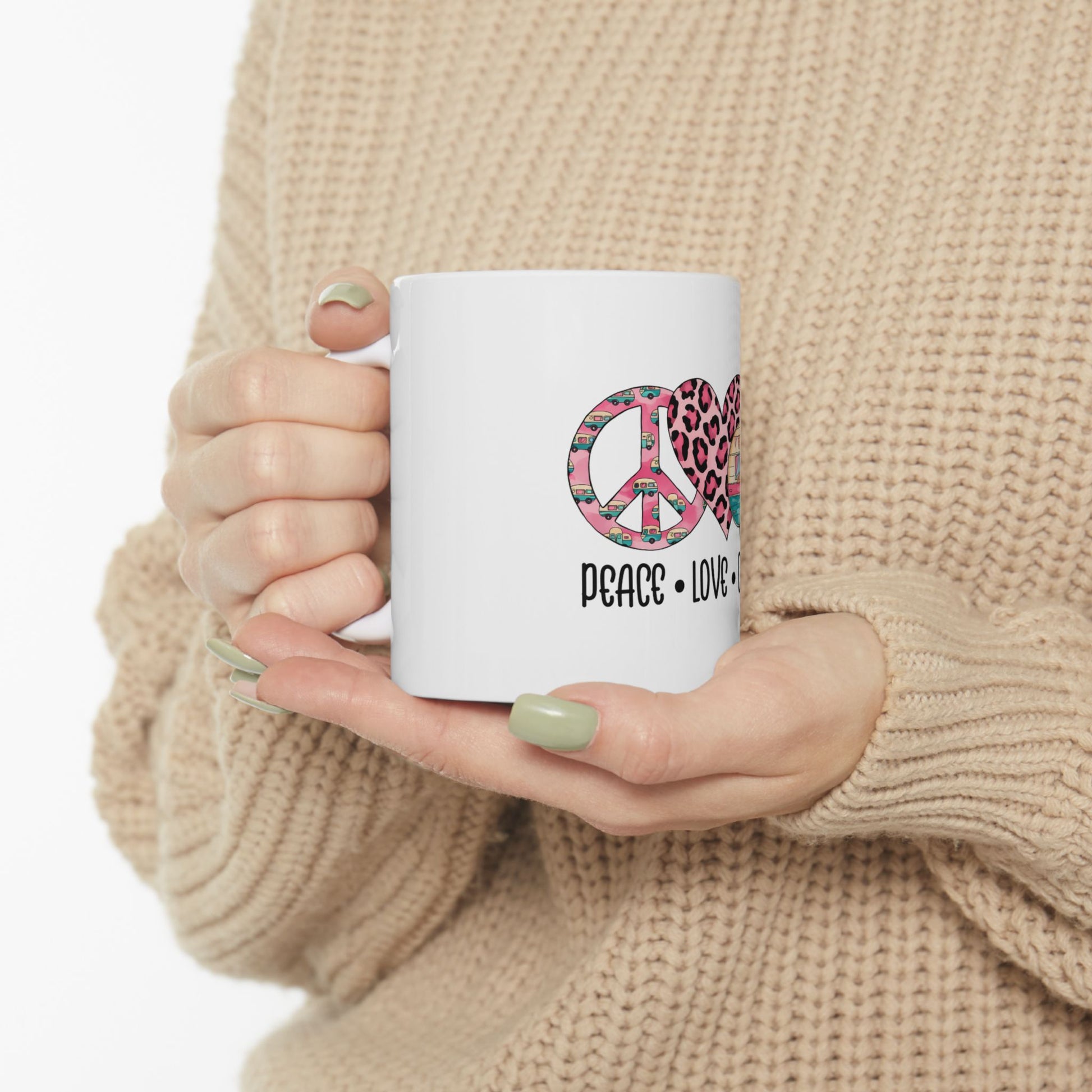 White mug with "PEACE LOVE" text and pink leopard print heart graphic.