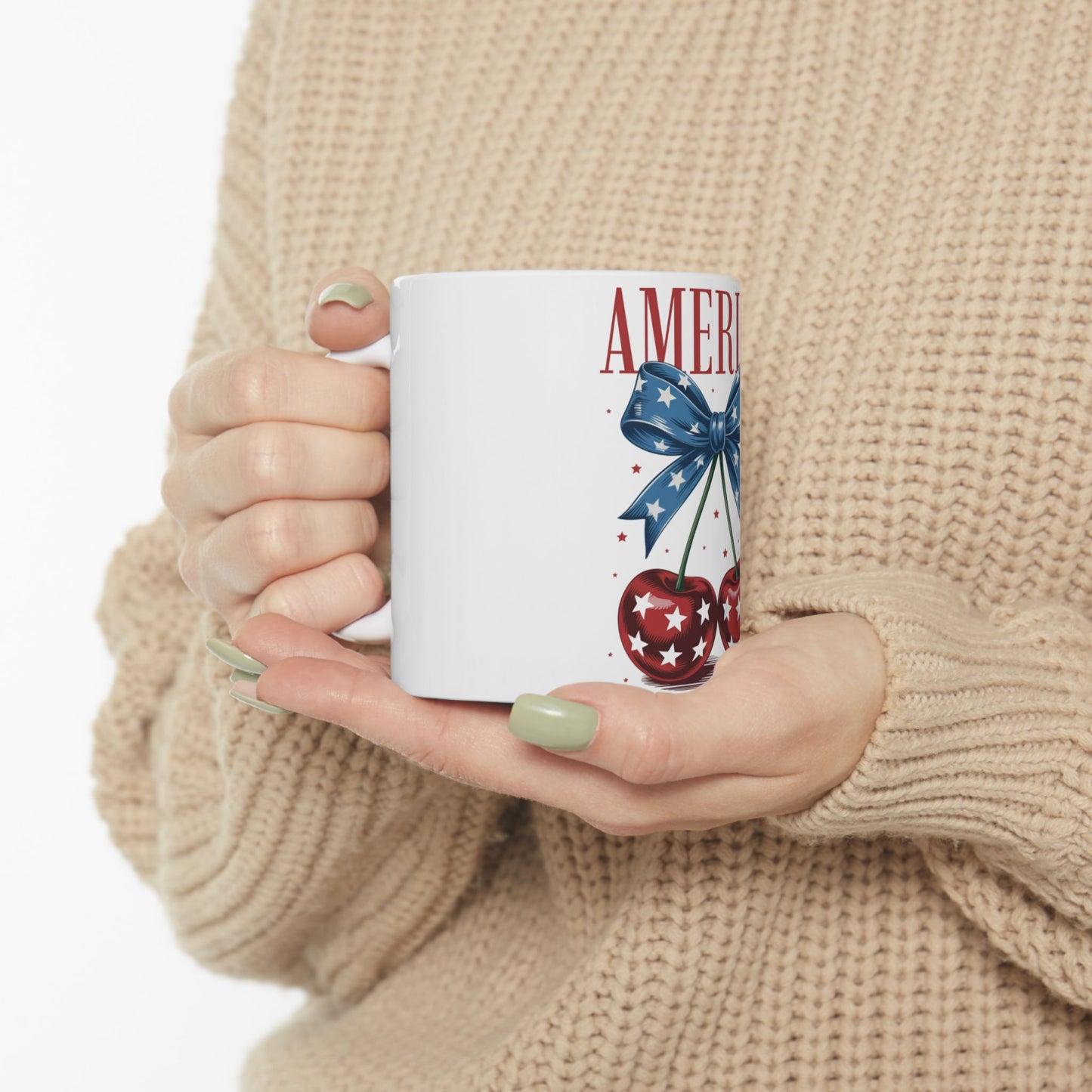 White mug with cherries and "AMERICA" text, tied with a blue bow.