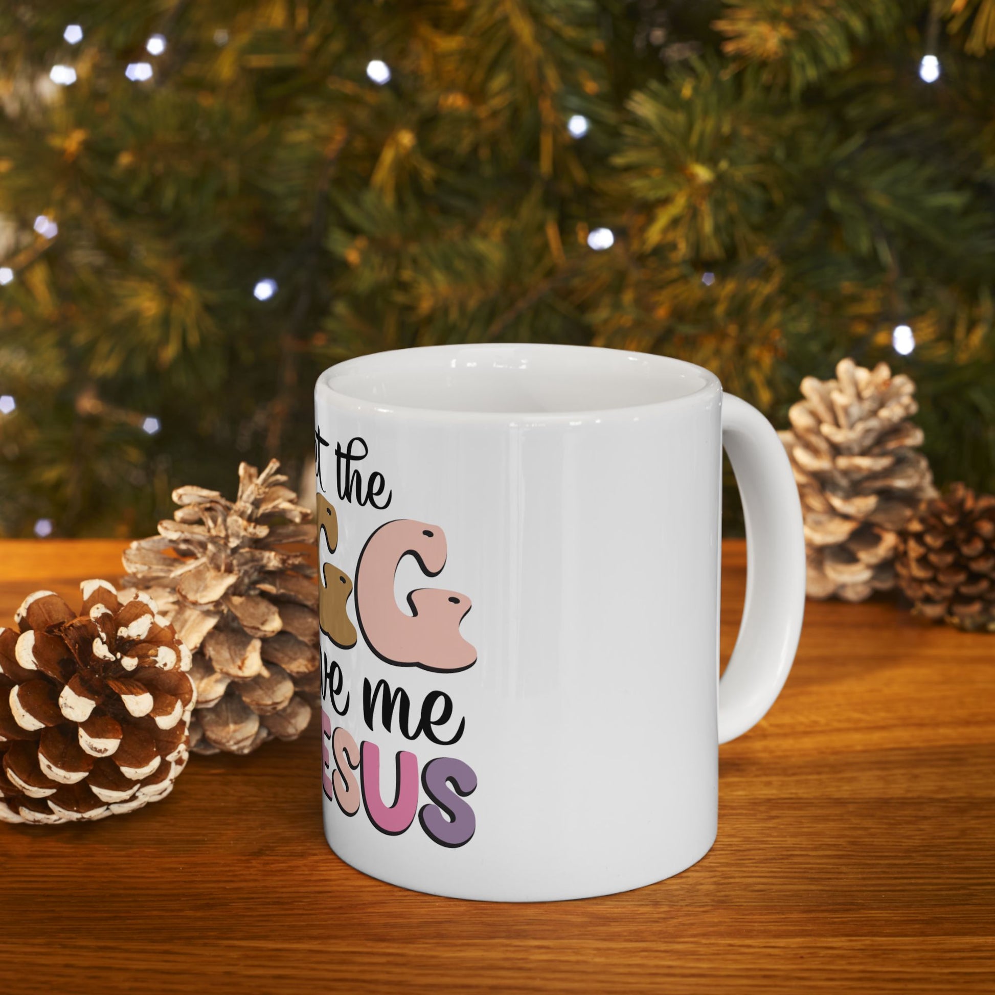 White mug with "Let the G&G love me Jesus" text, decorated with pinecones.