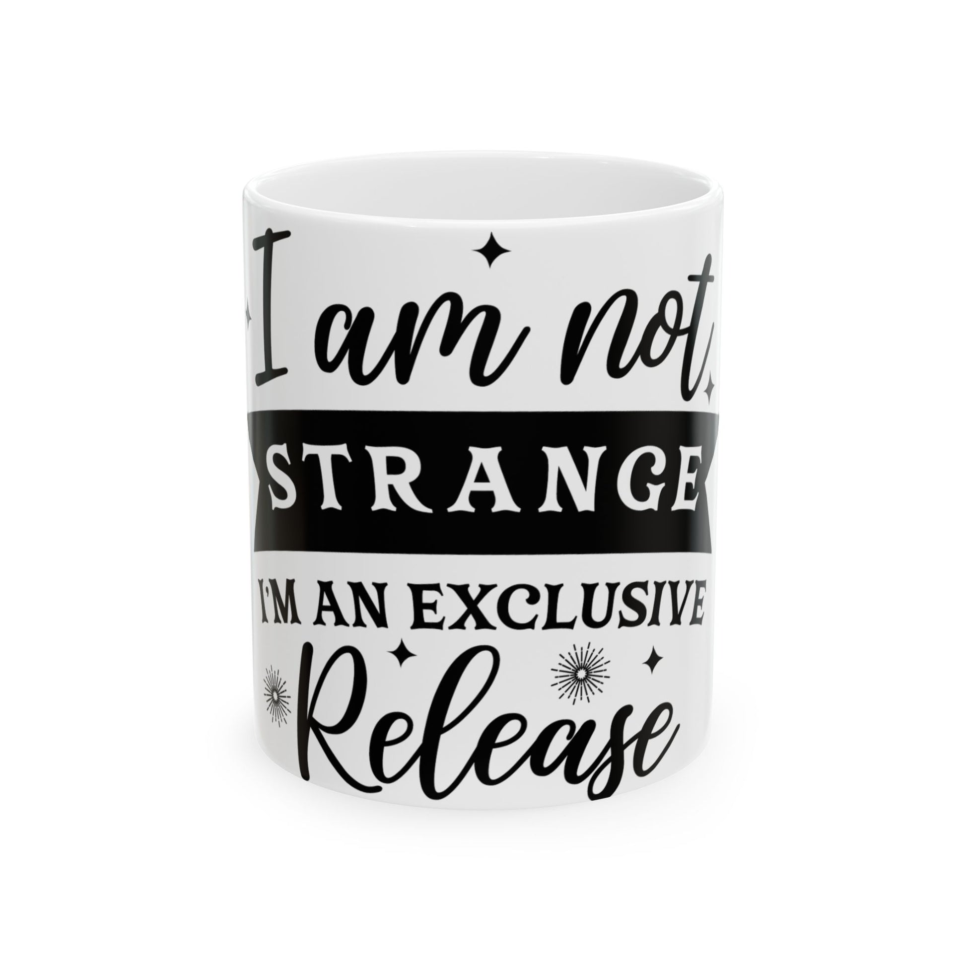White mug with black text "I am not STRANGE I'M AN EXCLUSIVE Release".