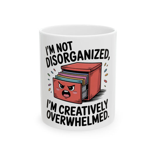 Mug with a cabinet and text "I'm not disorganized, I'm creatively overwhelmed."
