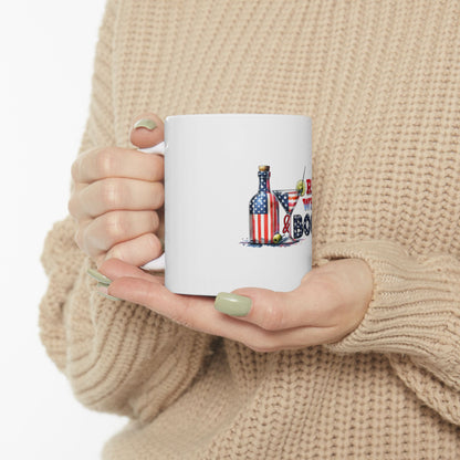 White mug with American flag martini glass and bottle graphic.