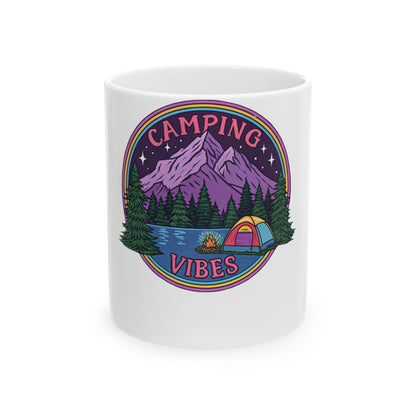 White mug with colorful camping scene featuring tent, lake, mountains, and text.