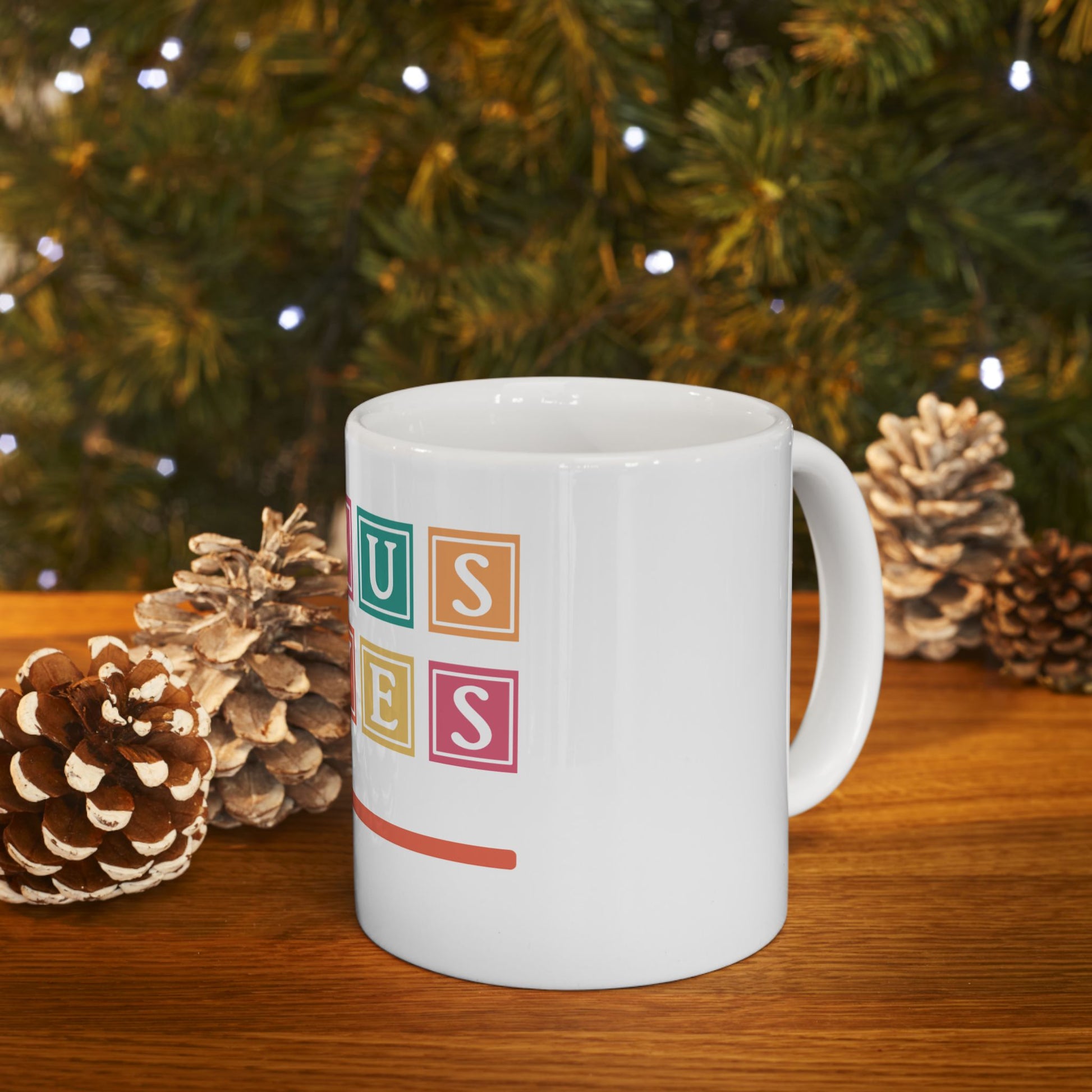 White mug with "Uses" spelled out in colorful blocks and an orange line.
