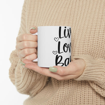 White mug with "Live Laugh Love" text in black cursive font.