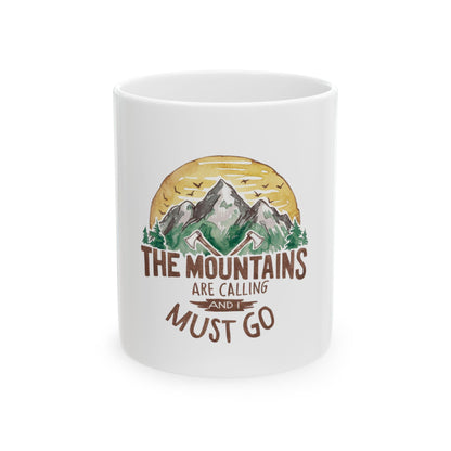 White mug with mountains, trees, and text "The Mountains Are Calling".
