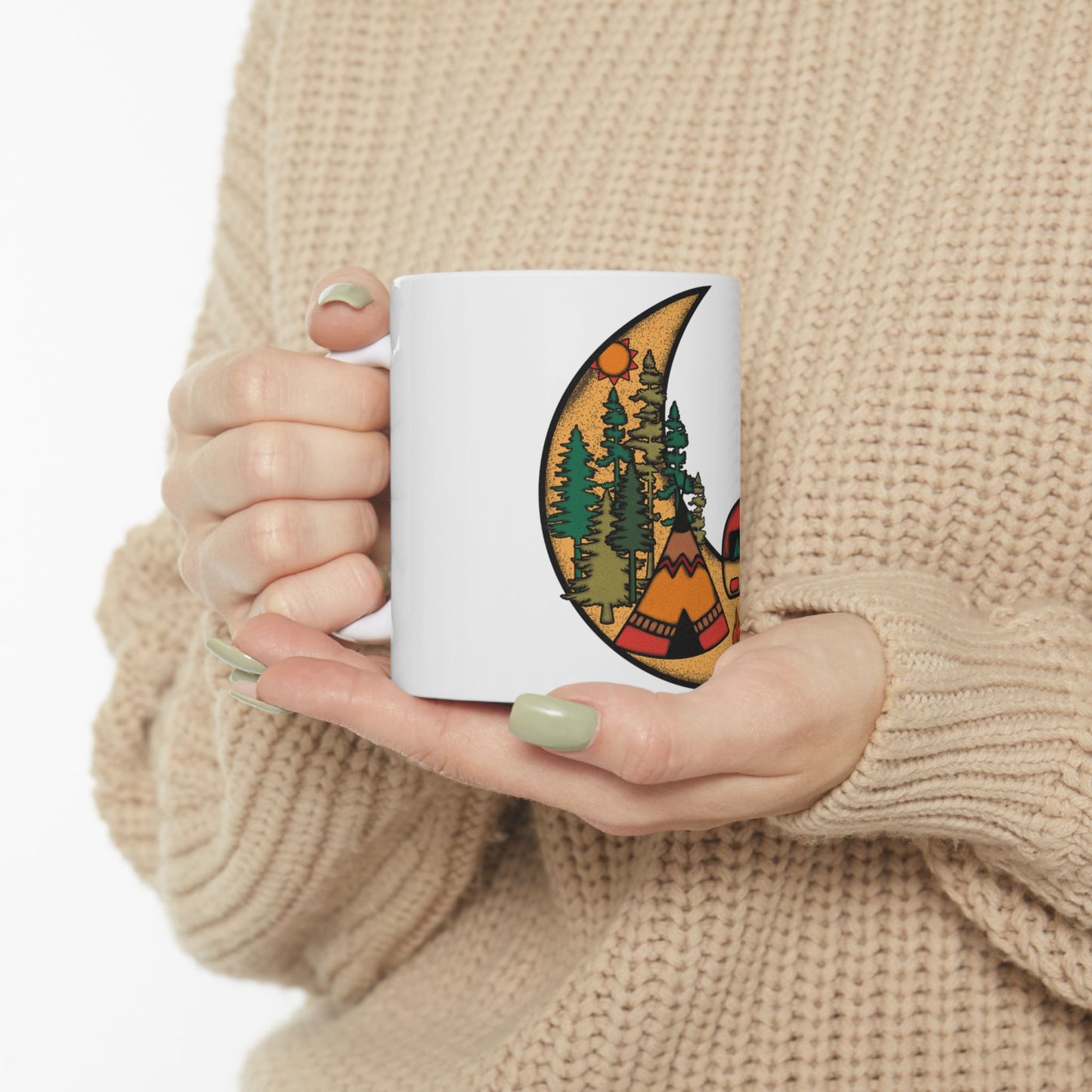 Mug with crescent moon, tent, and evergreen trees against a sunset.