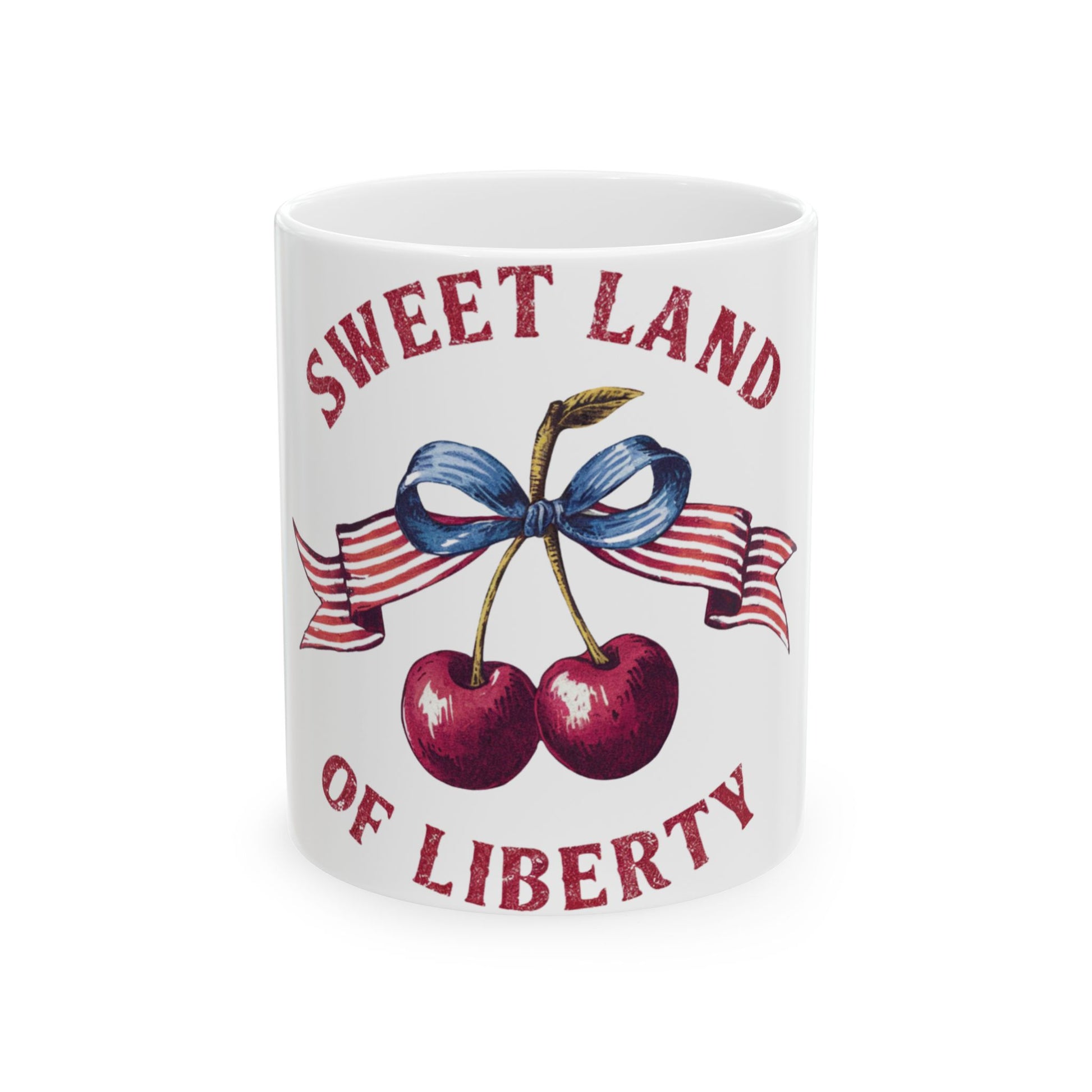 White mug with cherries, ribbon, and "Sweet Land of Liberty" text.