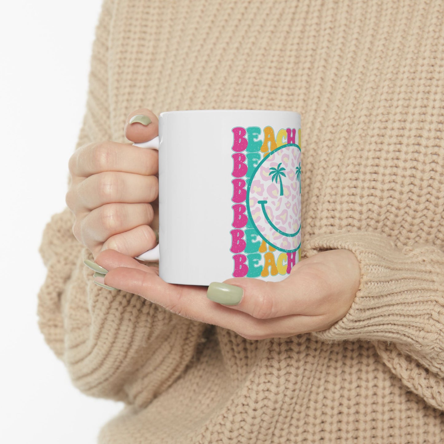 White mug with leopard print smiley face and "BEACH" text.