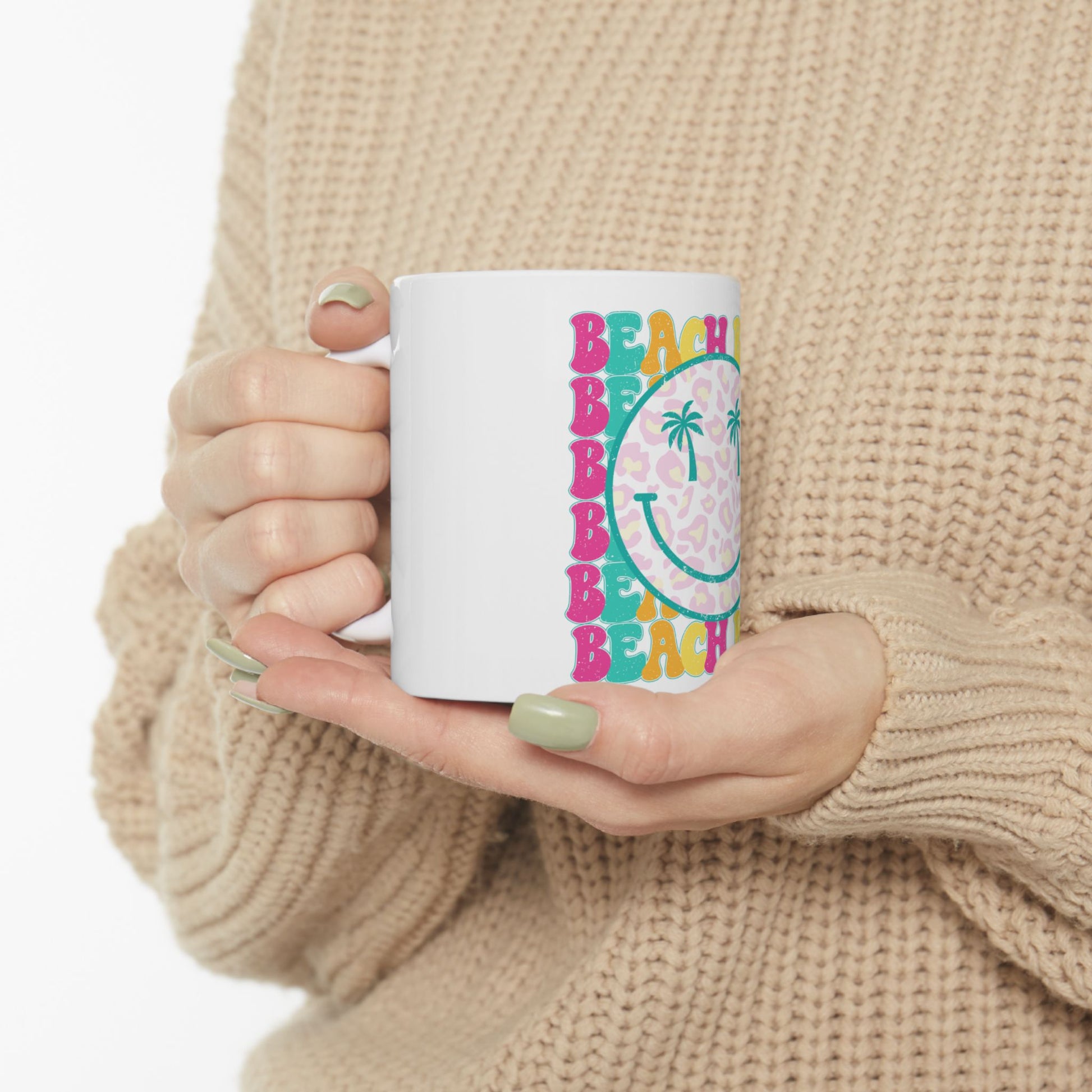 White mug with leopard print smiley face and "BEACH" text.