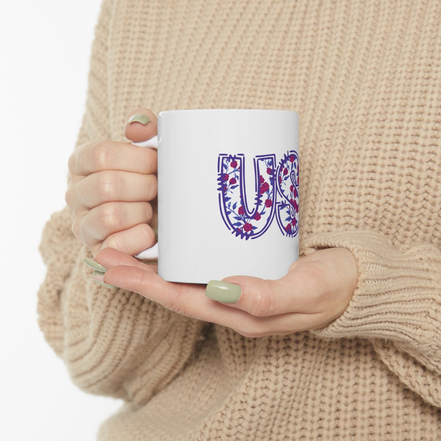White mug with a large purple floral letter "U" design.