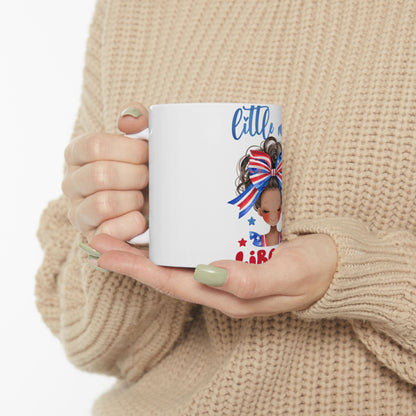 Woman holding a white mug with a patriotic girl design and "Little" text.