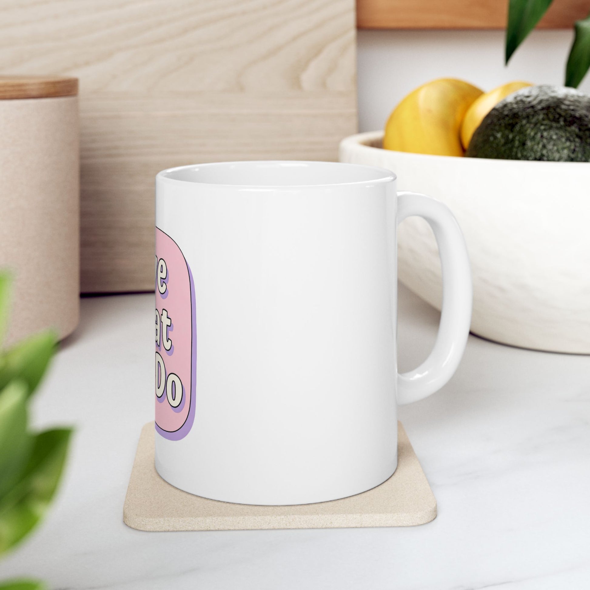 White mug with pink text "Love what I do" on a coaster.