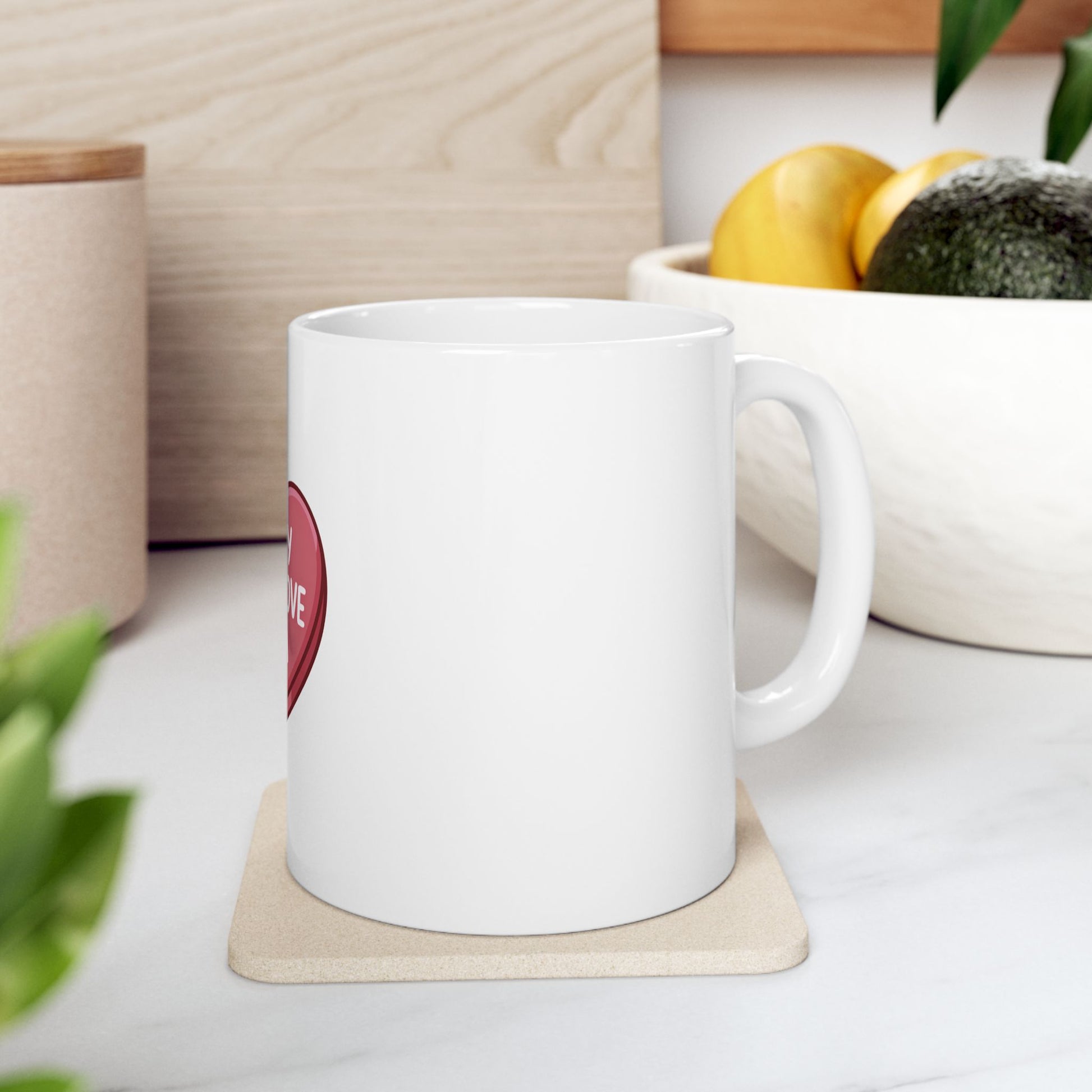 White mug with "Love" in a red heart on the side, on a coaster.