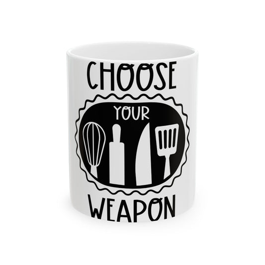White mug with black text and kitchen utensil icons.