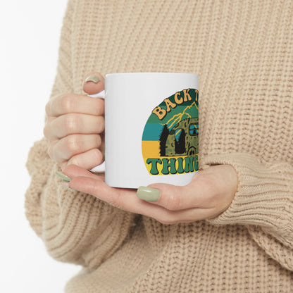 White mug with "Back to Nature" text and camper van graphic.