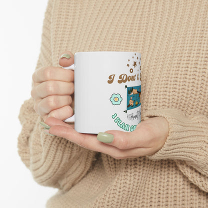 White mug with "I Don't Plan. I Fly On Instinct" text and camping graphic.
