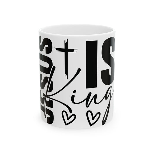 White mug with black text "Jesus is King" and small heart designs.