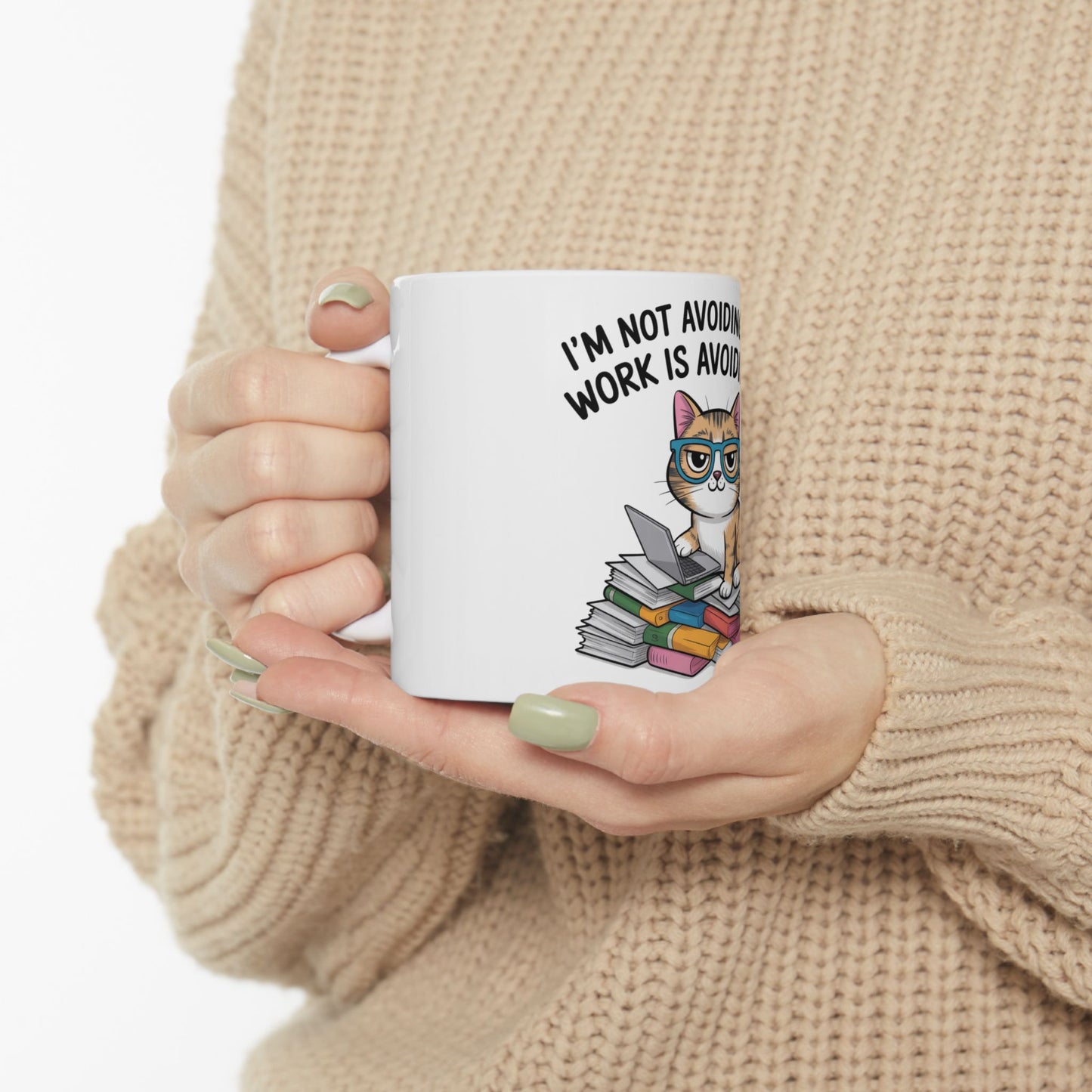 White mug with a cartoon cat, glasses, and text: "I'm not avoiding work is avoid".