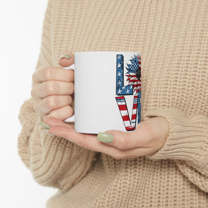White mug with "LOVE" design featuring a sunflower and American flag.