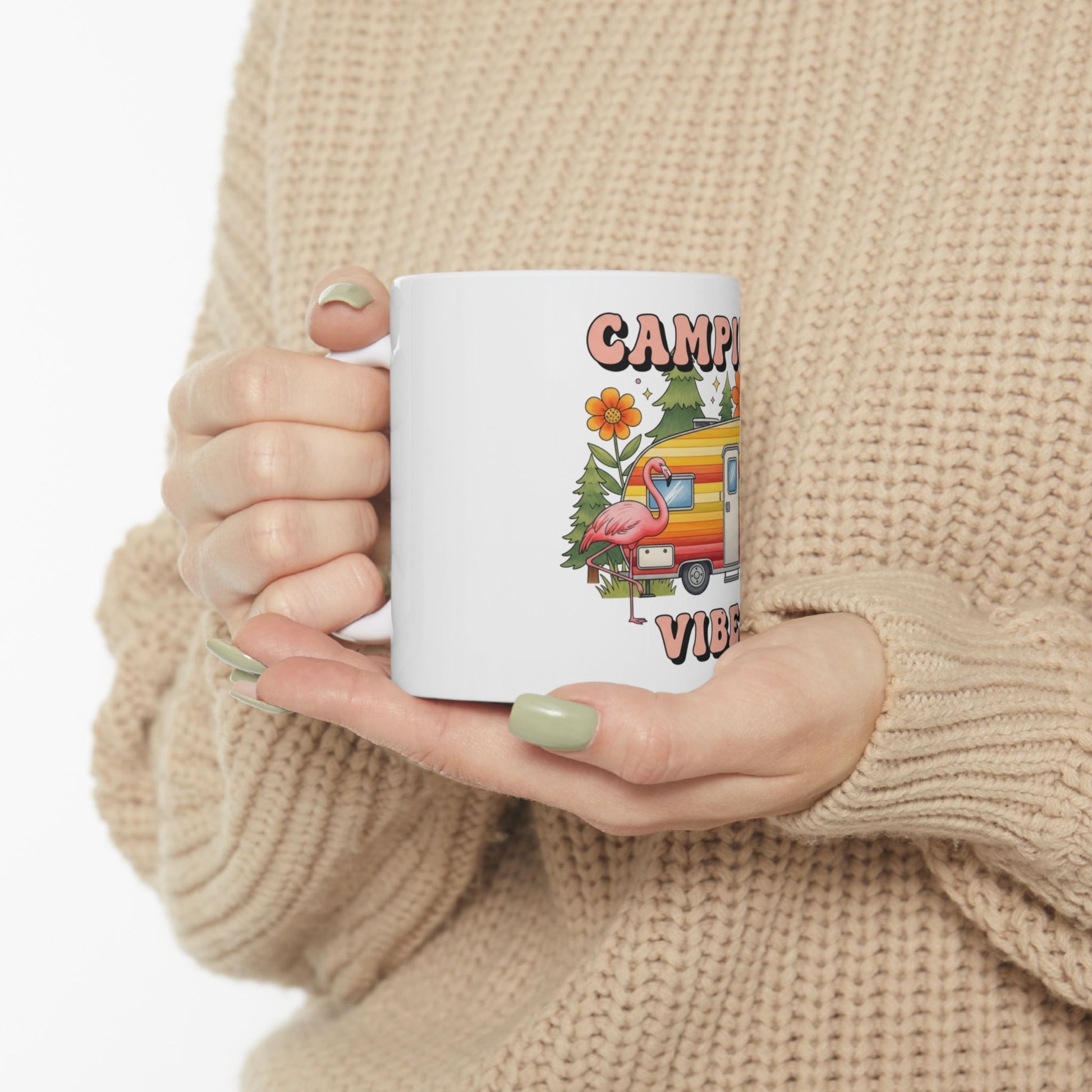 White mug with cartoon camper, flamingo, and text "Camping Vibes".