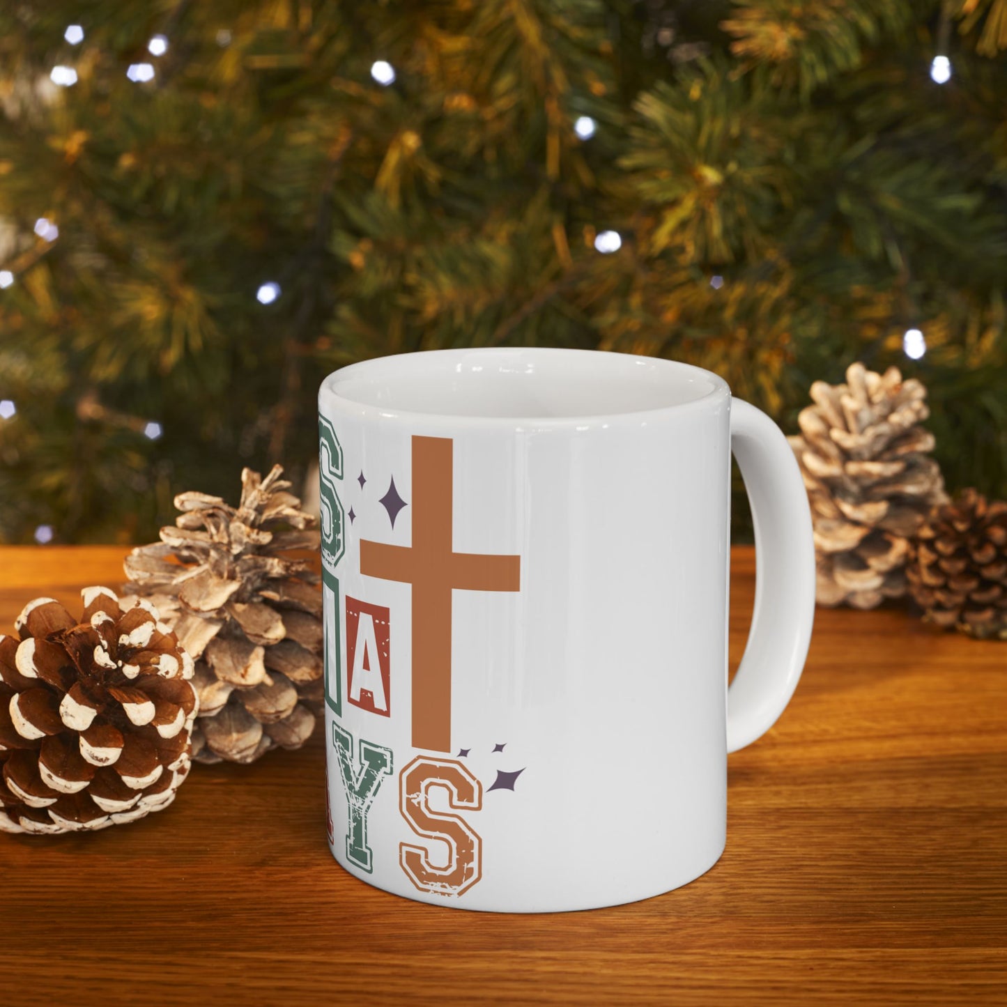 White mug with "Jesus saves" and a cross design, on a table.
