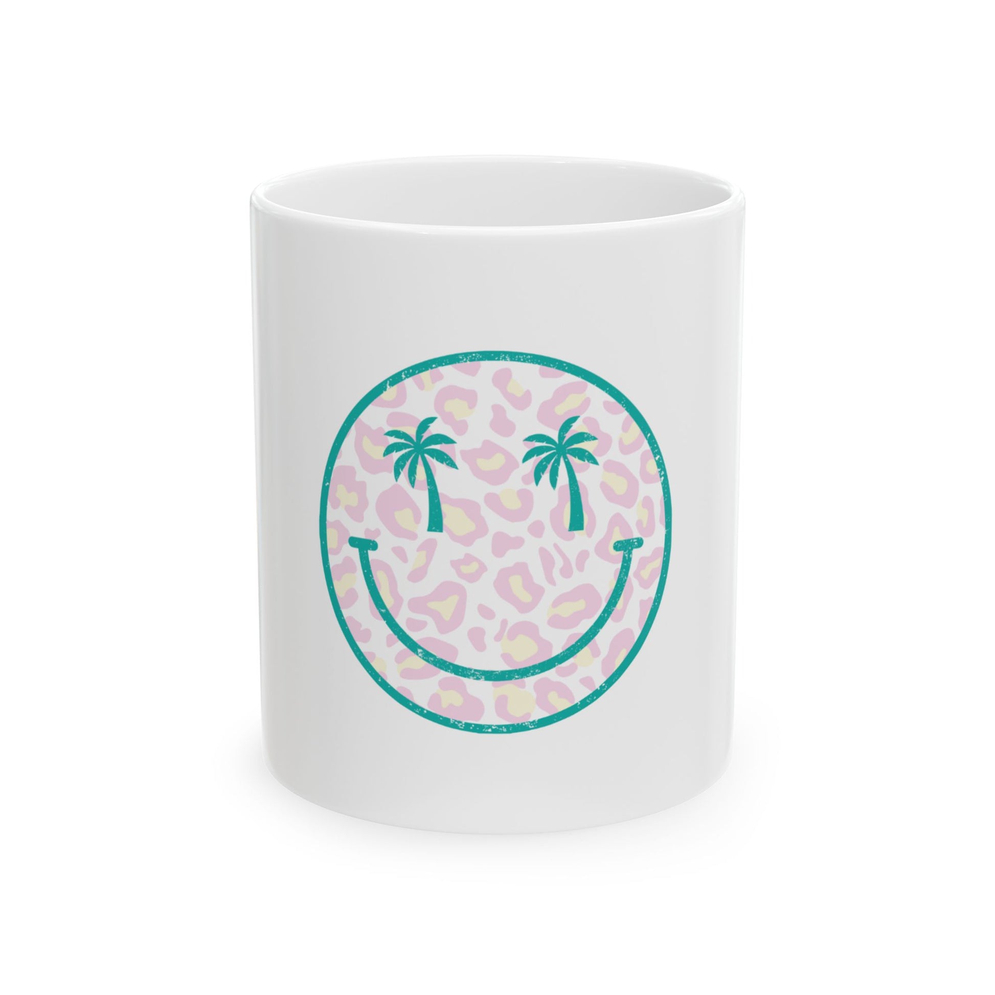 White mug with teal smiley face graphic with palm trees on leopard print.