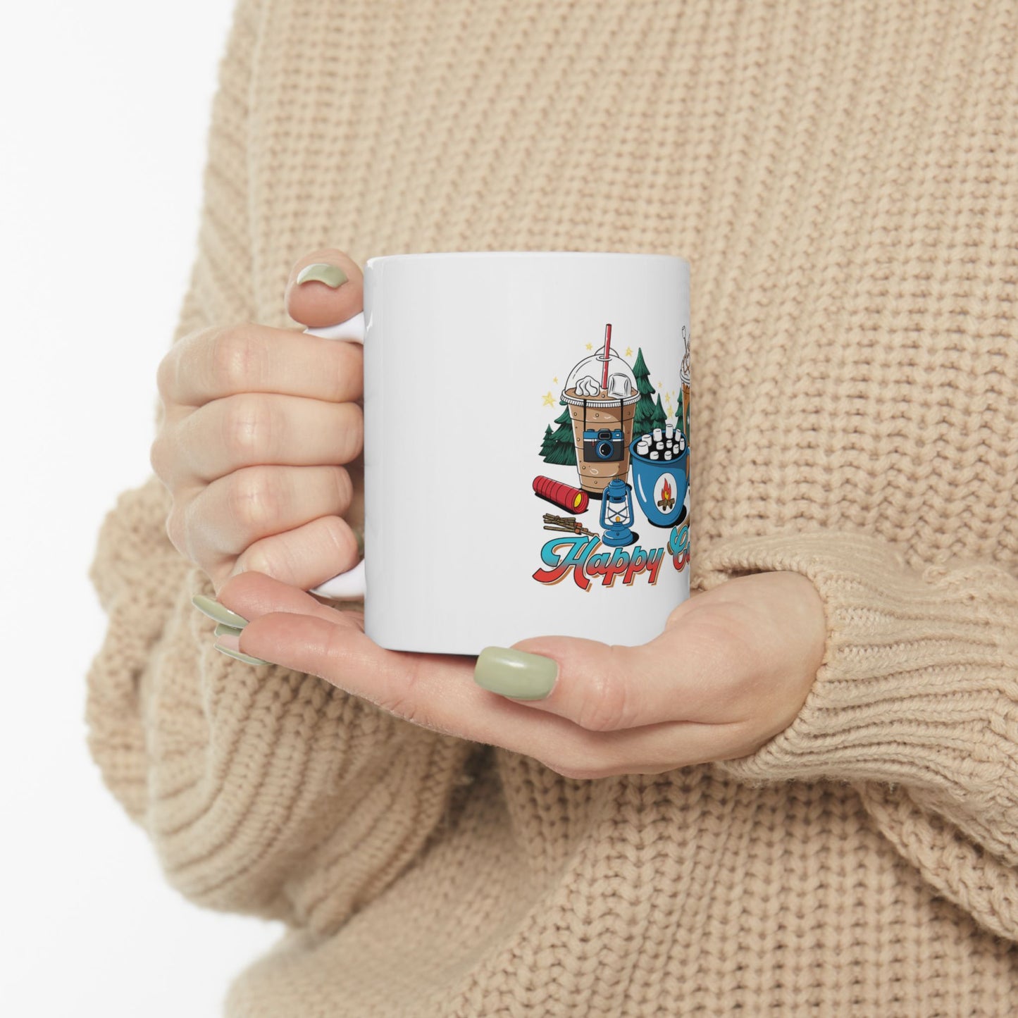 White mug with camping theme design and "Happy Camper" text.