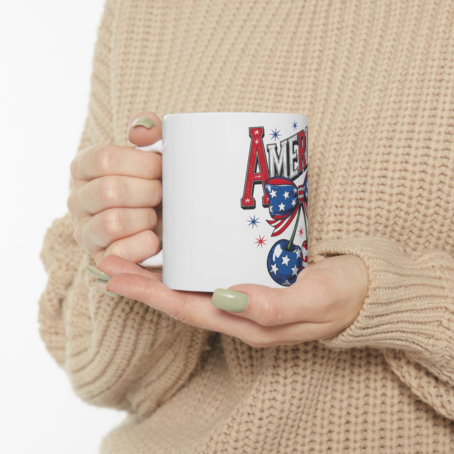White mug with "AMERICA" text, cherry, and stars and stripes pattern.