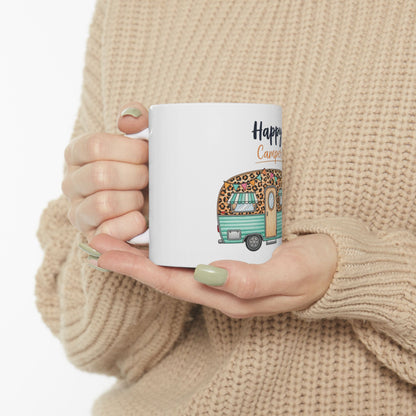 White mug with "Happy Camper" text and a leopard-print caravan illustration.